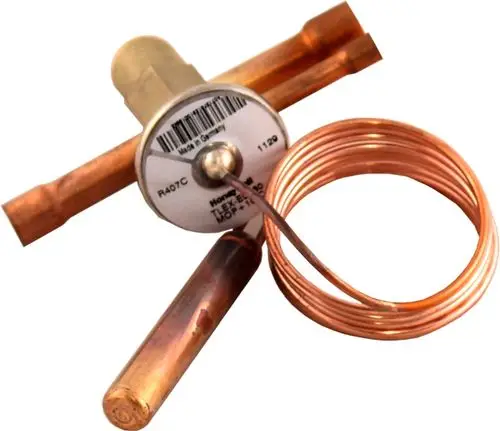 Thermostatisches Expansionsventil von Wolf, bestehend aus einem Metallkörper und Kupferrohren, mit einer gewickelten Copper-Spule an einer Seite.